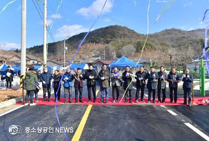 장성읍 잠암마을 주민들이 24일 도로 확포장 공사 준공식을 갖고 자축하고 있다.